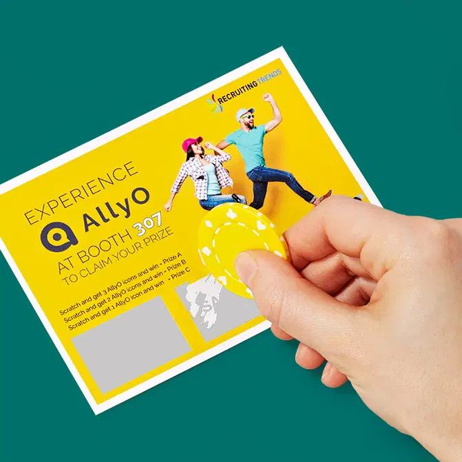 Yellow AllyO trade-show scratch-off card being scratched by hand